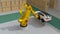 Yellow heavyweight robotic arm carrying white SUV in logistics center.