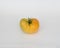 A yellow heirloom tomato isolated on white