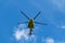 Yellow helicopter flies overhead