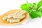 Yellow herbal medicine on wooden spoon with green leaf