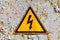 Yellow high voltage triangle warning sign