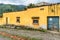 Yellow house & procession carpet in Guatemalan village