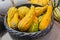 Yellow hybrid zucchini and pumpkins in a basket
