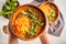 Yellow Indian vegan lentil soup curry with parsley and sesame in