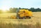 Yellow industrial combine harvester.