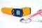 Yellow Infrared thermometer gun used to measure temperature with stethtoscope  on white background