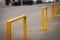 Yellow iron barriers blocking parking.