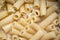 Yellow italian cooked pasta tortiglioni in a pan