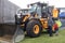 Yellow JCB tractor being viewed by a family