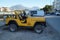 A yellow jeep is parked near the Fethiye waterfront.