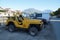 A yellow jeep is parked near the Fethiye waterfront.