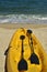Yellow kayak and black paddles on beach in tropical Baja, Mexico