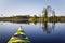 Yellow kayak on a calm forest lake. Kayak in focus, background blurred