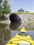 Yellow kayak on river going to the tunnel