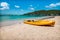 Yellow kayak on white sand beach of Bequia, St Vincent and the Grenadines.