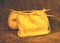 yellow knitted hat  knitting needles with yarn  handmade  warm knits