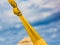 Yellow knot of hammock on the blue sky background, close-up. Su