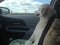 Yellow Labrador Retriever riding in the front seat of a car