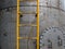 Yellow Ladder on silver metal wall Background