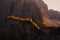 Yellow larches backlighted by rising sun, Dolomites, Italy