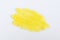 Yellow lemon face or body exfoliating scrub texture. Beauty mask smear on white background. Cosmetic product swatch macro