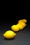 Yellow Lemon fruits in a Line over Black