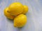 Yellow lemons close up on a blue wooden table