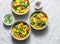 Yellow lentils and vegetables potatoes, carrots, cauliflower, turnips and turmeric thick vegetarian soup on  light background,