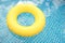 Yellow lifebuoy swimming in the pool in water
