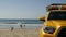 Yellow lifeguard car, ocean beach California USA. Rescue pick up truck, lifesavers vehicle.