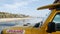 Yellow lifeguard car, ocean beach California USA. Rescue pick up truck, lifesavers vehicle.