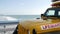 Yellow lifeguard car, ocean beach California USA. Rescue pick up truck, lifesavers vehicle.