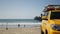 Yellow lifeguard car, ocean beach California USA. Rescue pick up truck, lifesavers vehicle.