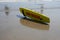 Yellow lifeguard surf rescue surf board by the ocean on the sand