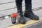 Yellow line, coffee, boots, sunny, sun, man, limit, border, red colour,
