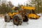 A Yellow Log Skidder Parked in the Snow