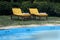 Yellow lounge chairs by a pool