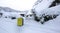 Yellow luggage on the road with snow as background