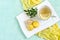 Yellow macaroon and tea with lemon in cup