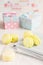 Yellow macaroons with gift boxes on background