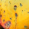 Yellow macro photograph of soap bubble with blue and red shapes forming