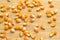 Yellow maize corn kernels ready for making popcorn, on bamboo cutting board