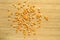 Yellow maize corn kernels ready for making popcorn, on bamboo cutting board