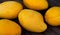 Yellow mango closeup. Bunch of tropical fruits. Oval yellow mango pile.