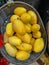 Yellow mangos in a basket for sale