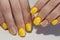 Yellow manicure nail design with stones