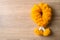 Yellow marigold flower garland on wooden background