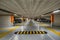 Yellow markings with blurred modern cars parked inside closed underground parking lot