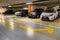 Yellow markings with blurred modern cars parked inside closed underground parking lot