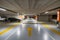 Yellow markings with blurred modern cars parked inside closed underground parking lot